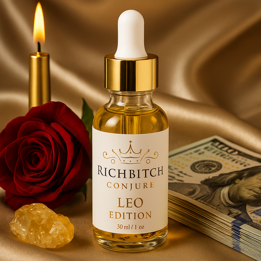 Luxury ritual flatlay featuring Rich Bitch Conjure Oil Leo Edition with red rose, citrine crystal, gold candle, and hundred-dollar bills on champagne silk background. Perfect for Leo Season and Lion’s Gate manifestation rituals.