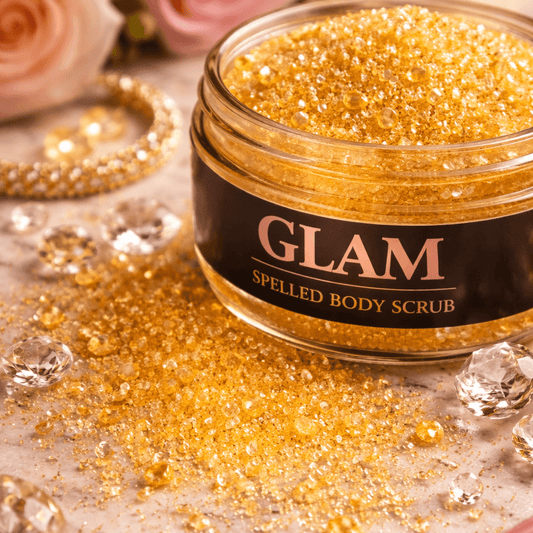 Jar of gold glittery body scrub with 'GLAM' label on a decorative background